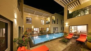 A pool area with lounge chairs and a pool. - Maroma Suites (Chennai)