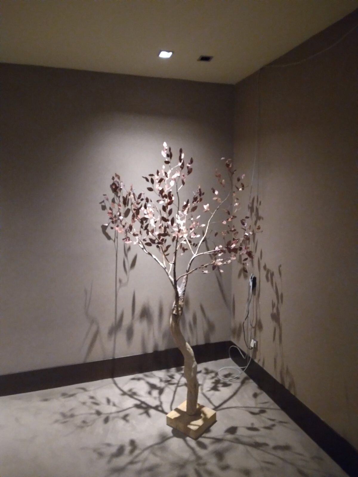 A modern art installation in a room with a simple, neutral color scheme.