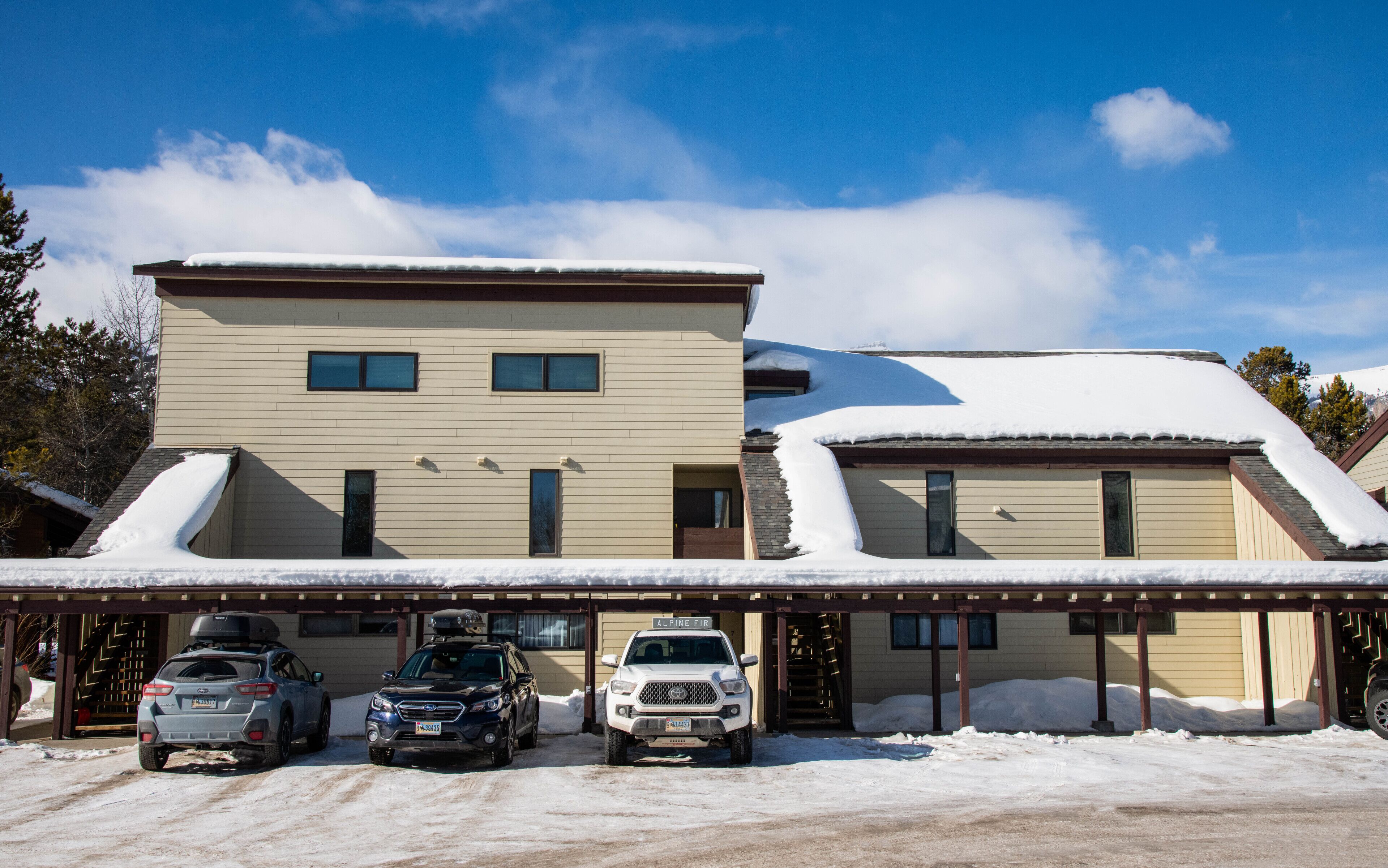 A two-story building with a covered parking area.