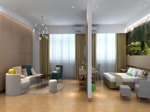 A modern hotel room with a curved sofa, a bed, a desk, and a large window with curtains. - Greentree Inn Guiyang Wudang District High-speed Railway East Station (Guiyang)