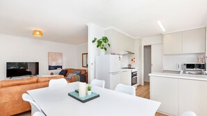 A modern apartment with a living room, dining area, and kitchen. - MaryMae - Town Central (Port Fairy)