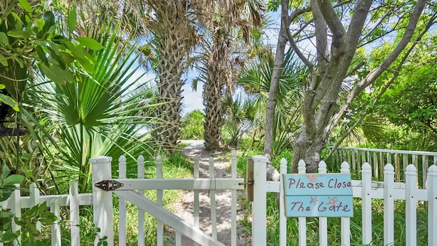 A gated entrance with a sign reading "Please Close The Gate." - Heated Pool, Tiki Lounge, Steps to Beach, Games (St. Augustine)