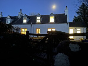 A traditional house with multiple windows and a visible chimney. - No 4 old Post Office Row, Isle of Skye (Skeabost)