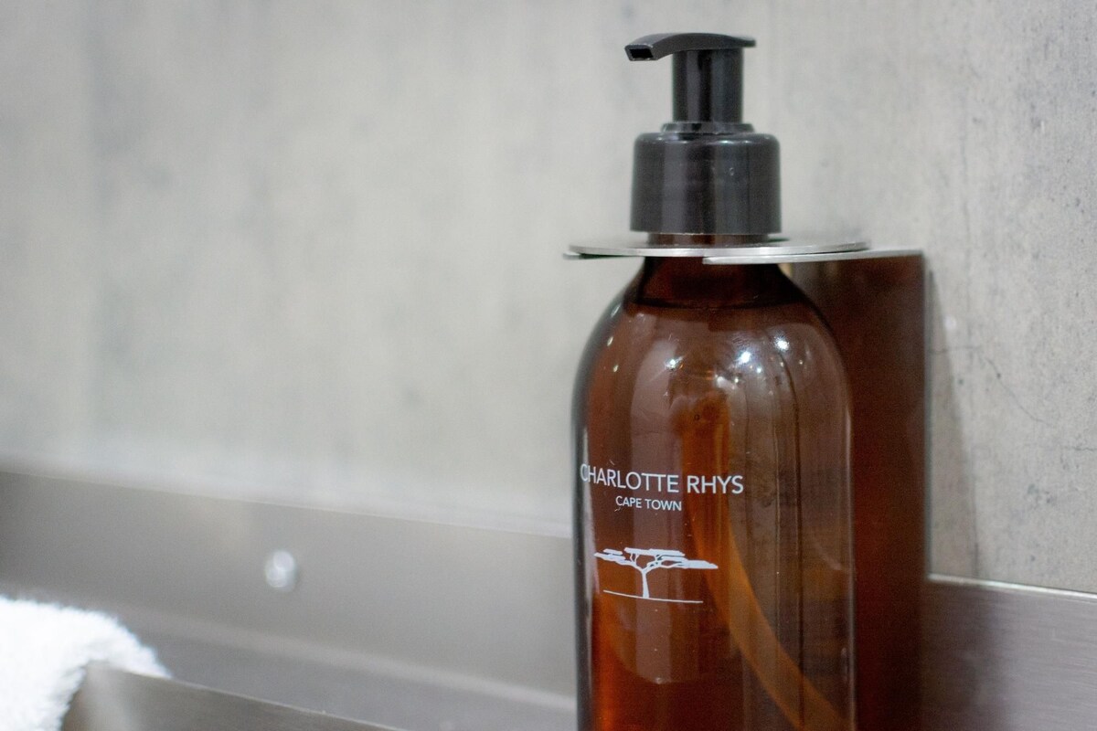 A bottle of Charlotte Rhys Cape Town body wash on a bathroom counter.