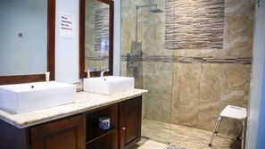 A bathroom with two sinks, a shower, and a toilet. - Maranatha Villa (Discovery Bay)