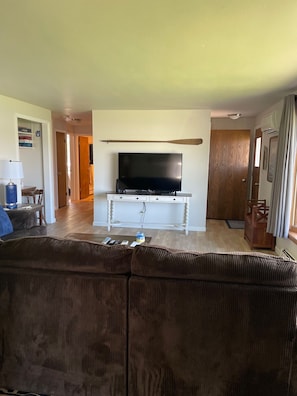 Relax in this cozy living space with a large flat-screen TV and comfortable sofa.