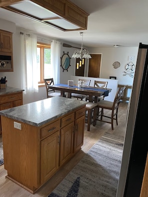 Enjoy cooking in this well-equipped kitchen with a central island, oven, and dining area.
