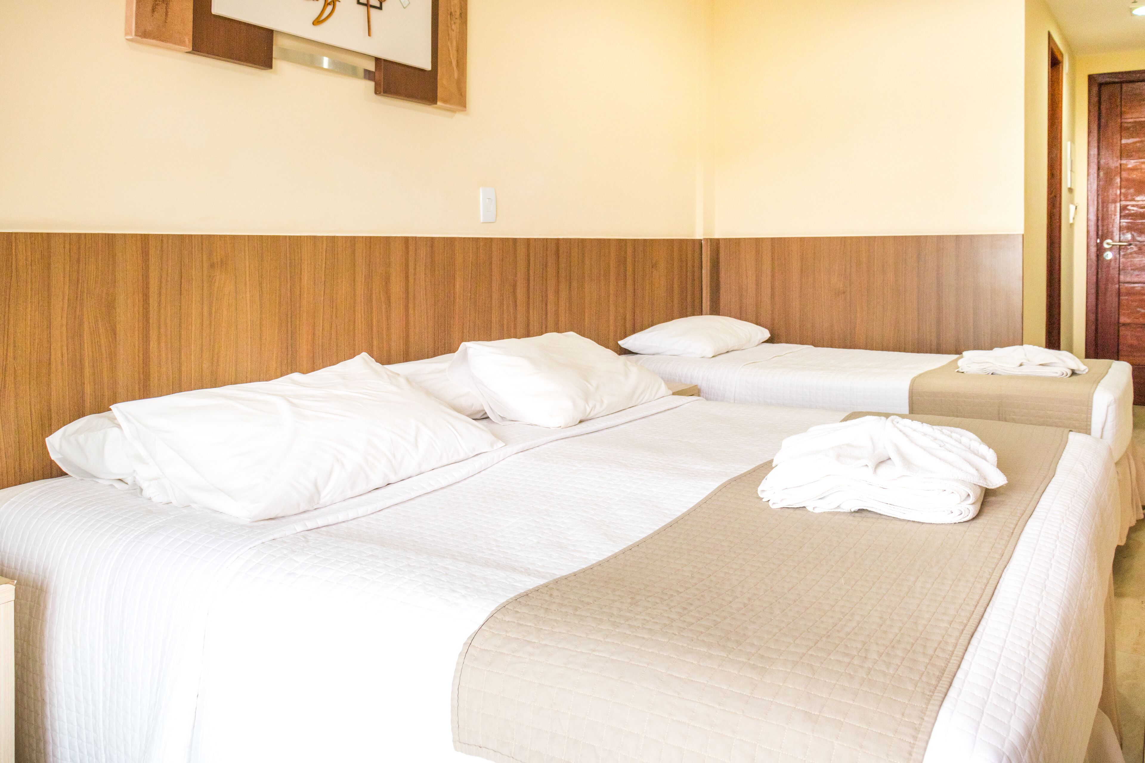 deluxe triple room | in-room safe, laptop workspace, blackout curtains, iron/ironing board