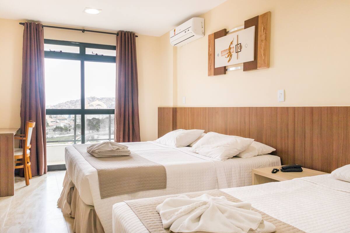 deluxe triple room | in-room safe, laptop workspace, blackout curtains, iron/ironing board