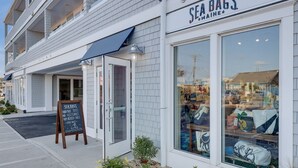 A storefront with a sign reading "SEA BAGS MAINE" and a display window showcasing various bags and accessories. - Harbourtown Suites (Plymouth)