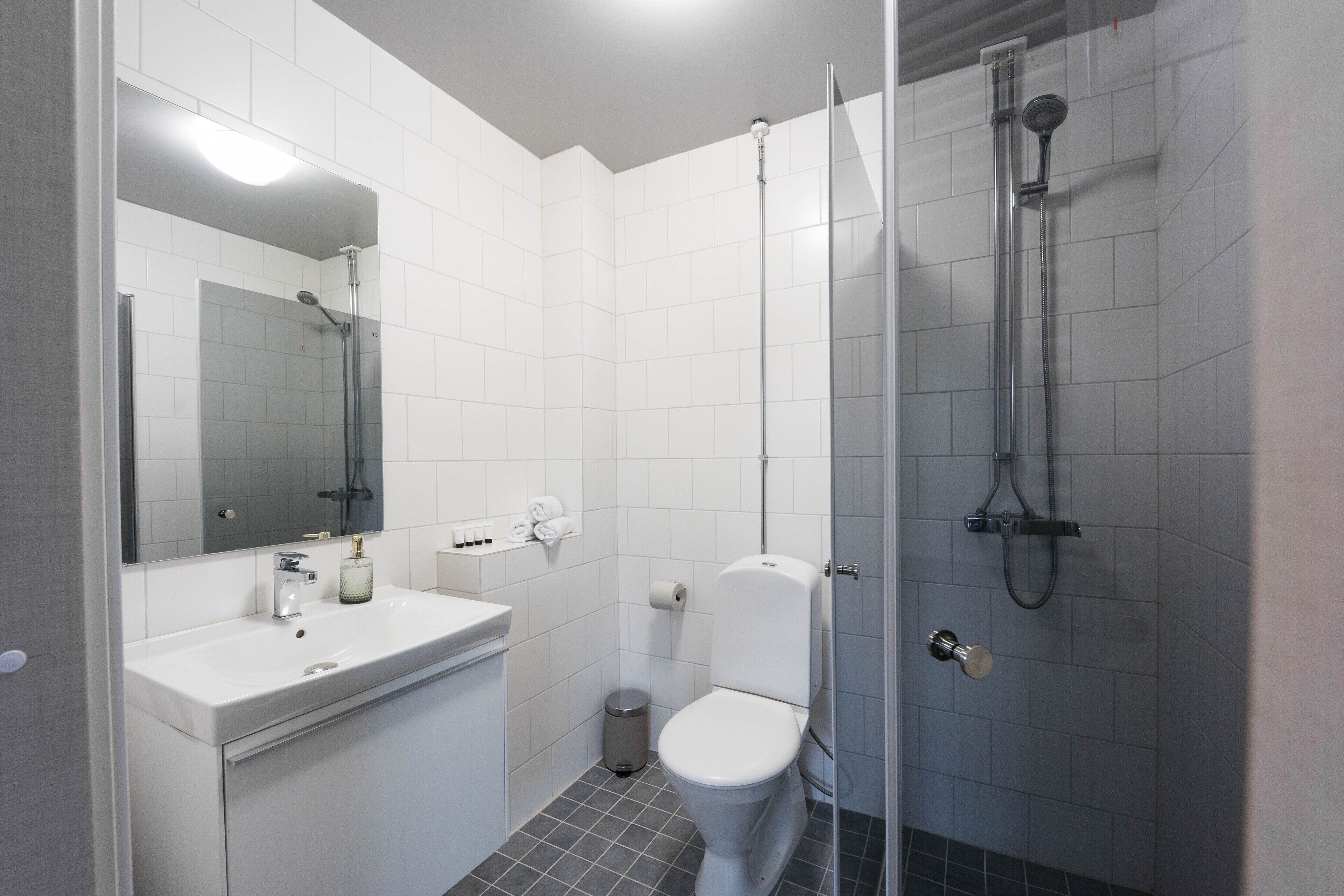 Shower, rainfall showerhead, hair dryer, towels
