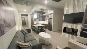 A modern living room with a gray sofa, a round coffee table, and a fireplace. - WorldMark Moab  (Moab)