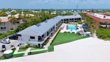 Um resort com piscina, várias varandas e vista para o oceano.