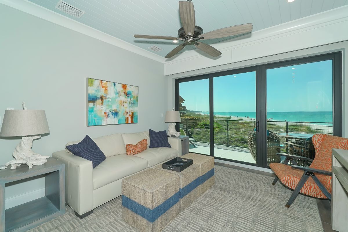 A modern living room with a large window offering a view of the ocean.
