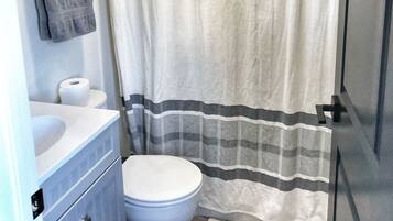 Combined shower/tub, hair dryer, towels, soap