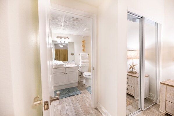 Un baño moderno con lavamanos, espejo y retrete.