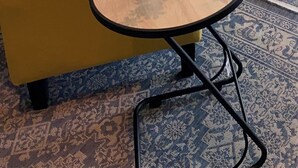 A living room with a sofa, a yellow armchair, a small round table with a vase of flowers, and a painting on the wall. - City centre Apartment/Energy Corridor (Houston)