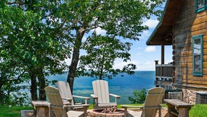 A wooden cabin with a fire pit and Adirondack chairs overlooking a lake. - Eagle’s Crest at Mentone-Amazing Views, sleeps 8 (Mentone)