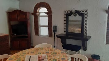 Laptop workspace, iron/ironing board, bed sheets