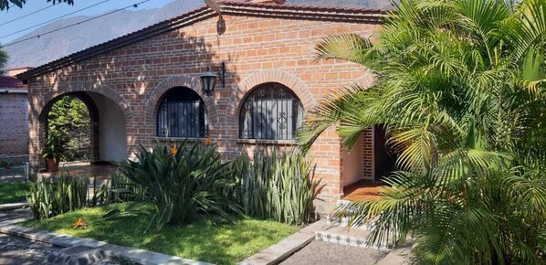 A brick building with arched windows and a small porch. - Capital O Posada Del Pescador Jocotepec (Jocotepec)