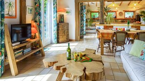 A cozy living room with a television, wooden coffee table, and a sofa. - 2 bedroom nice home in Plouguerneau (Plouguerneau)