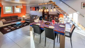 A modern living space with a dining area, a sofa set, and a staircase. - 3 bedroom awesome home in Moelan sur Mer (Moelan sur Mer)