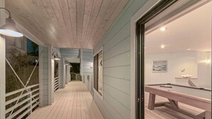 A wooden deck with a pool table and a billiards cue rack. - Oceanfront 4 bedroom villa w/ 2 masters and views (Encinitas)