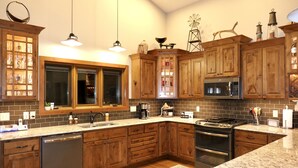 Una cocina con armarios de madera, lavavajillas de acero inoxidable, microondas y estufa.