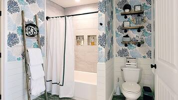 Combined shower/bathtub, towels, soap, toilet paper