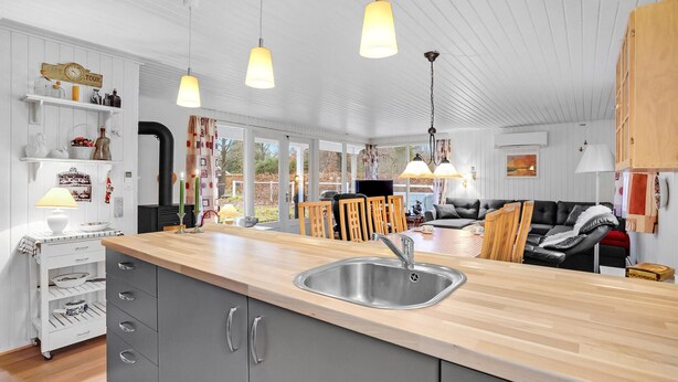 A modern kitchen with a large island, grey cabinets, and pendant lighting. - Gorgeous home in Ansager with WiFi (Ansager)