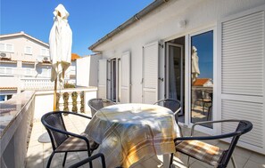 Relax in a serene patio with a round table and four comfortable chairs.