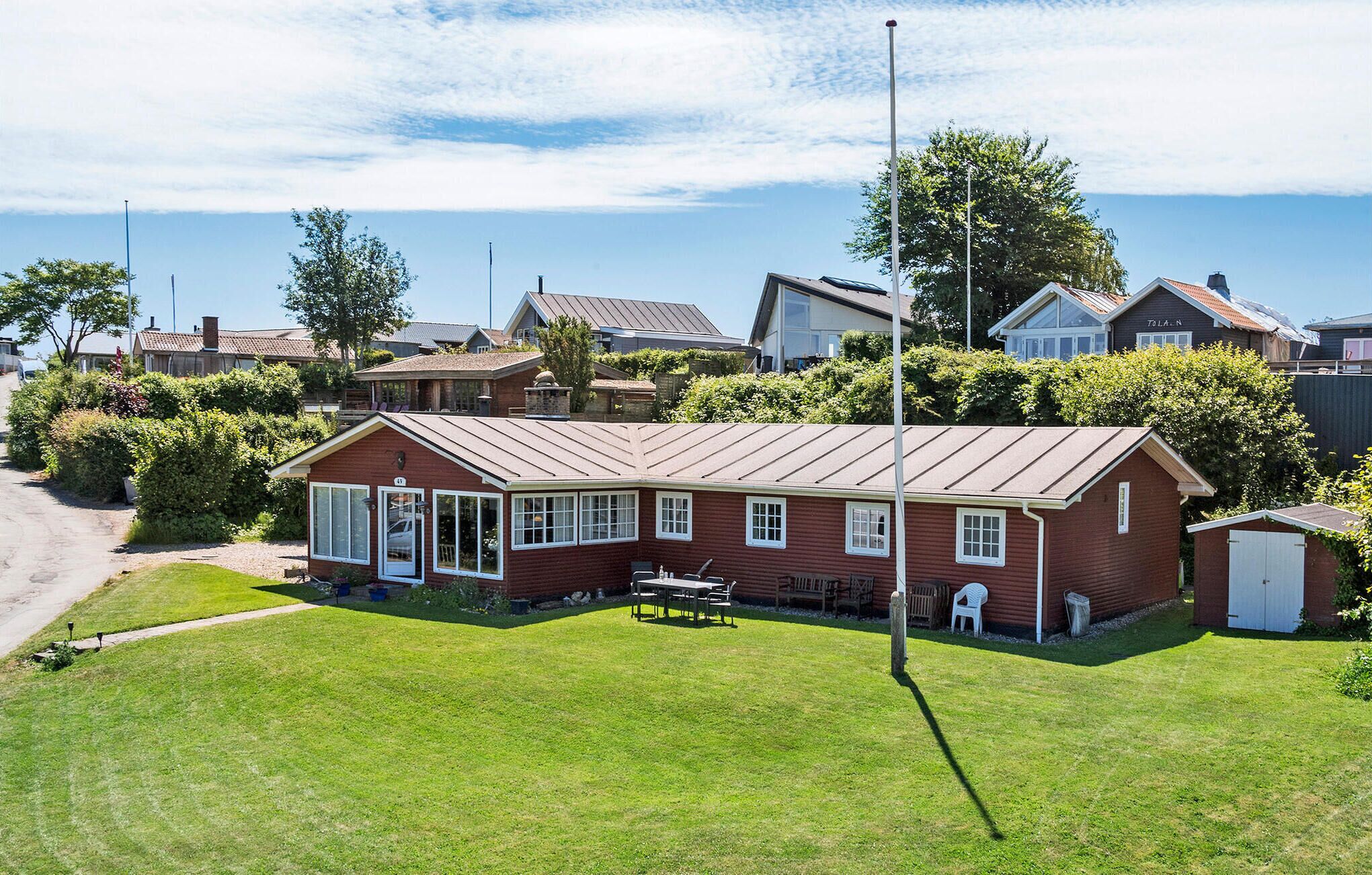 A single-story house with a sloped roof, a front porch, and a small attached garage.