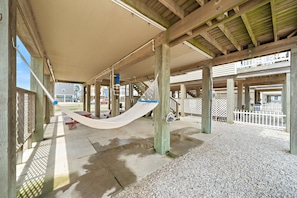 Relax in a serene outdoor space with a hammock suspended between wooden pillars.