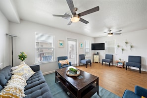 Relax in this stylish living space, featuring a sofa, armchairs, and a coffee table.