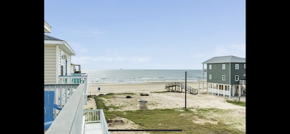 Enjoy breathtaking ocean views from the balcony and access to a deck area leading directly to the sandy beach.