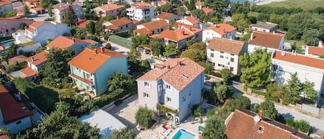 A residential area with houses, a swimming pool, and a marina with boats.