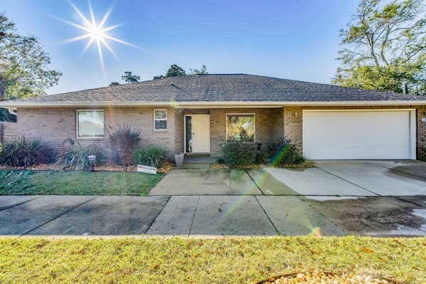 A single-story house with a garage, a front door, and a small porch.