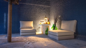 A cozy room with two beige armchairs, a small table with a lantern, and a green bottle. - Lovely home in Viagrande (Viagrande)