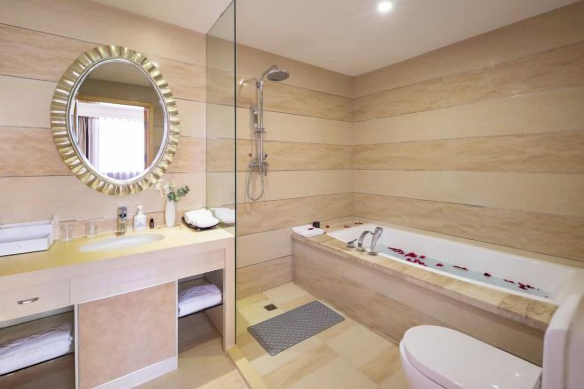 A modern bathroom with a shower, a bathtub, and a toilet.