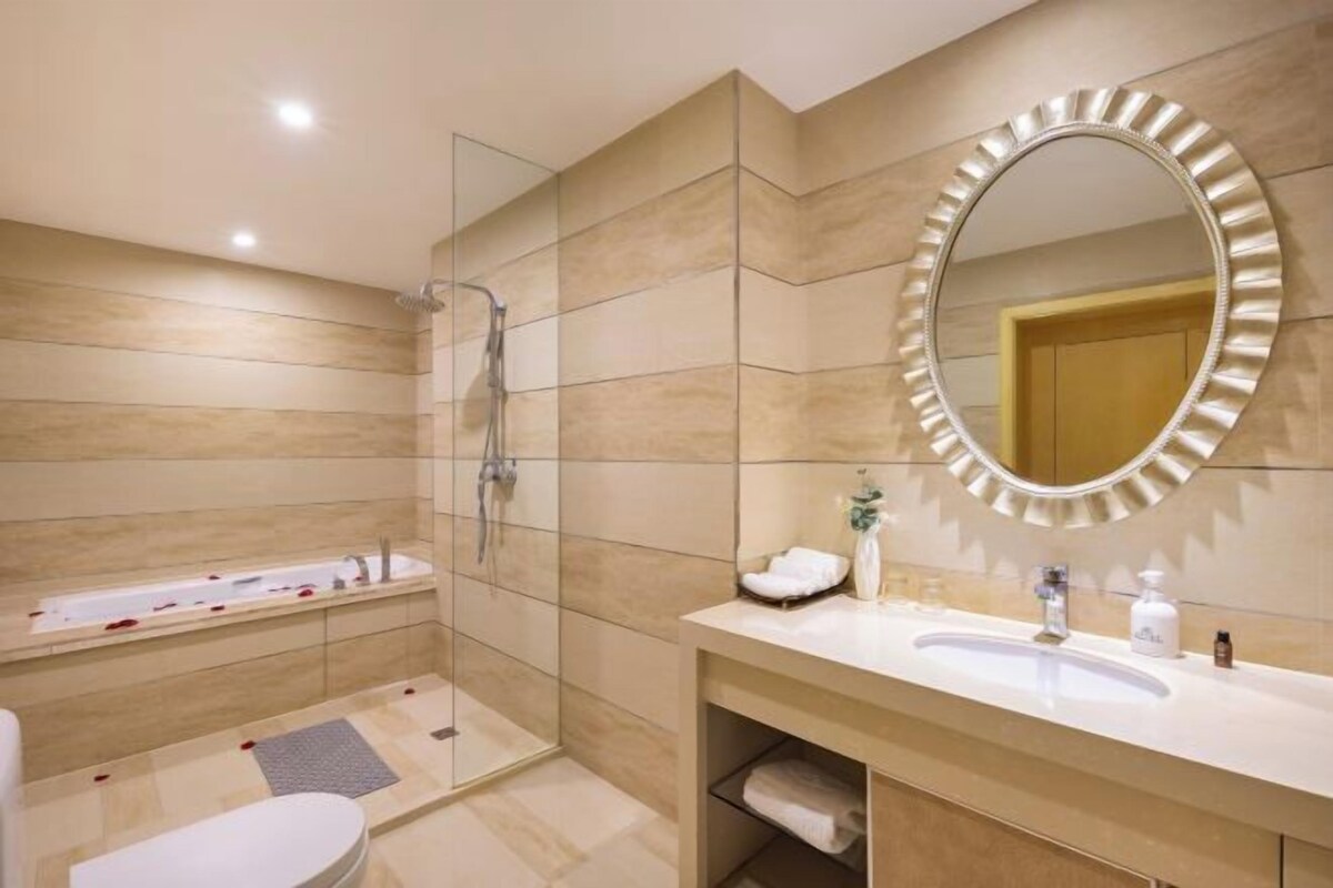 A modern bathroom with a shower, bathtub, and vanity.