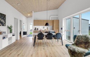 Enjoy a stylish space with a dining area, kitchen, and large window.