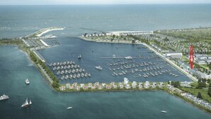 An aerial view of a marina with boats, a helipad, and residential buildings. - Holiday Apartment "Reeders Nest by Seeblick Ferien" with Sea View (OstseeResort Olpenitz)