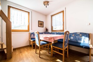 Ein Essbereich mit Holztisch, Stühlen und einer Bank.