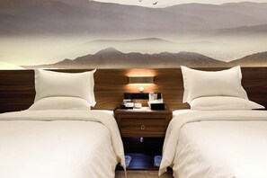 A hotel room with two beds, a nightstand with a lamp, and a view of mountains through the window. - Liuhe Hotel (Hengyang)