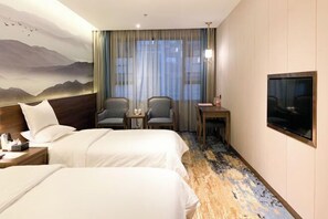 A hotel room with two beds, a desk, a chair, a TV, and a large window with curtains. - Liuhe Hotel (Hengyang)