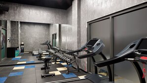 A gym with treadmills, dumbbells, and weight machines. - Tru by Hilton Viet Tri City Centre (Thanh Mieu)