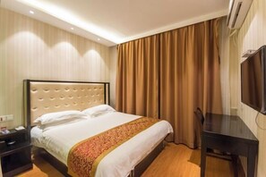 A hotel room with a large bed, a bedside table, a TV, and a curtain. - Baishang Hotel‌ (Wenzhou)