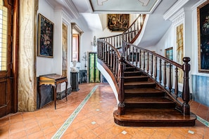 A grand staircase with a wooden handrail and a curved design, leading to an upper floor. - Villa in Colli Di Fontanelle with 4 bedrooms sleeps 8 (Colli Di Fontanelle)