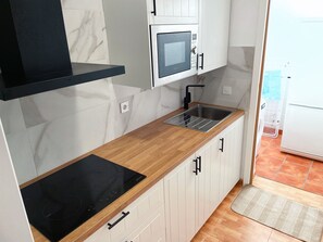 Fridge, microwave, stovetop, coffee/tea maker