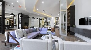Relax in this stylish living room with a large L-shaped sofa, coffee table, and flat-screen TV.